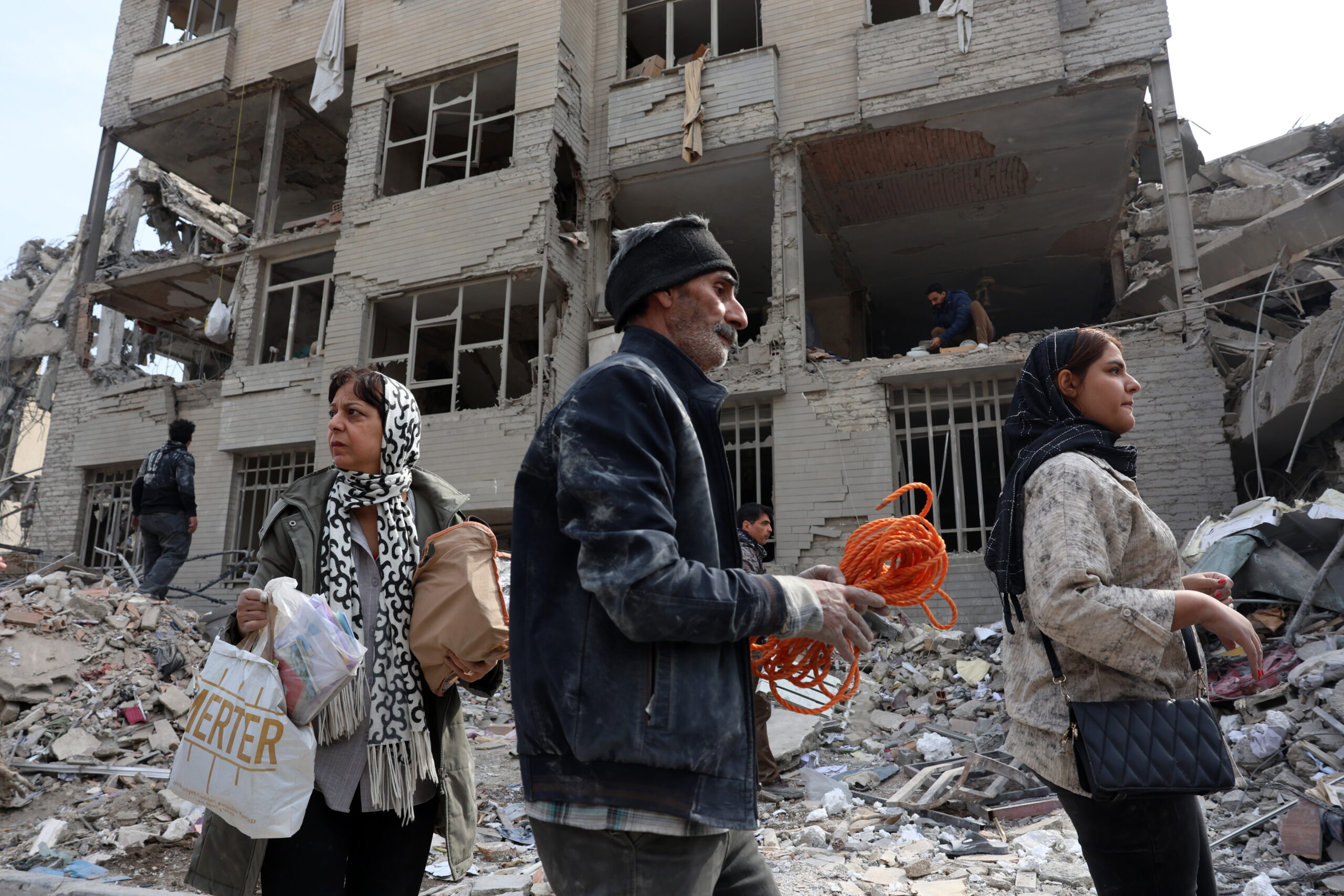 epa12813685 Iranians collect their belongings among the rubble of their damaged residential buildings in central Tehran, Iran, 12 March 2026. A joint Israeli and US military operation continues to target multiple locations across Iran since the early hours of 28 February 2026.