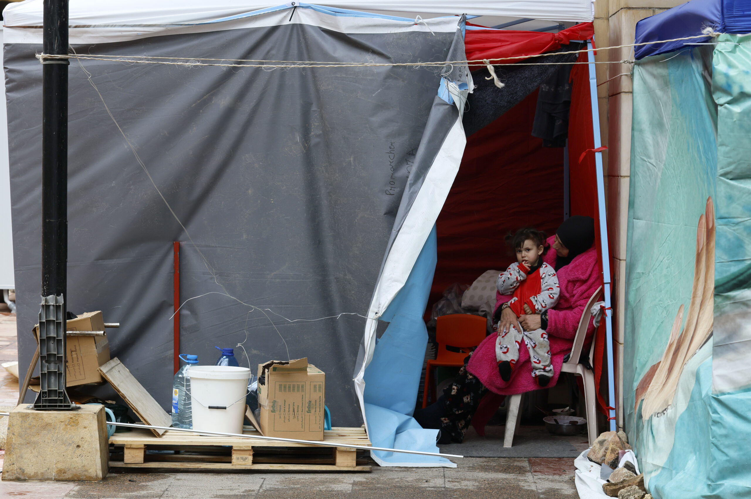 A displaced woman and a child sit in a tent in downtown Beirut, Lebanon, 15 March 2026. Lebanese authorities report more than 831,000 registered displaced since the escalation began on 02 March 2026, though the true number is likely higher, as many stay with relatives or seek shelter in safer areas.