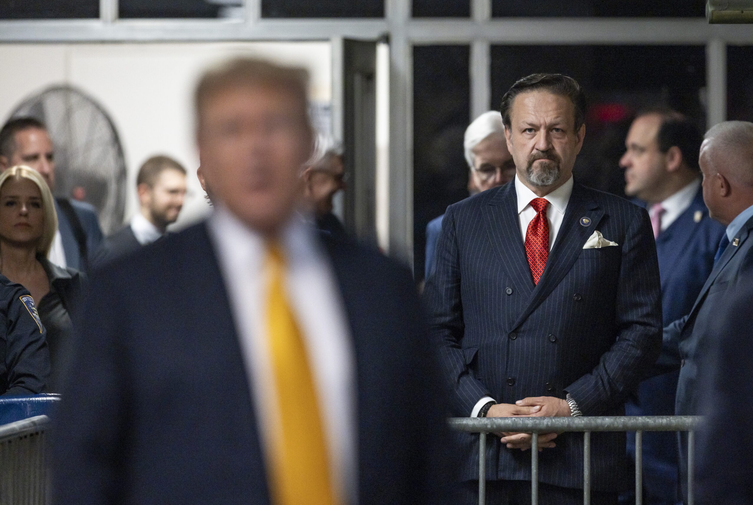 Radio host Sebastian Gorka (2-R) listens as former US President Donald Trump (L front) talks to reporters as he arrives for the afternoon session of his criminal trial at New York State Supreme Court in New York, New York, USA, 21 May 2024. Trump is facing 34 felony counts of falsifying business records related to payments made to adult film star Stormy Daniels during his 2016 presidential campaign.