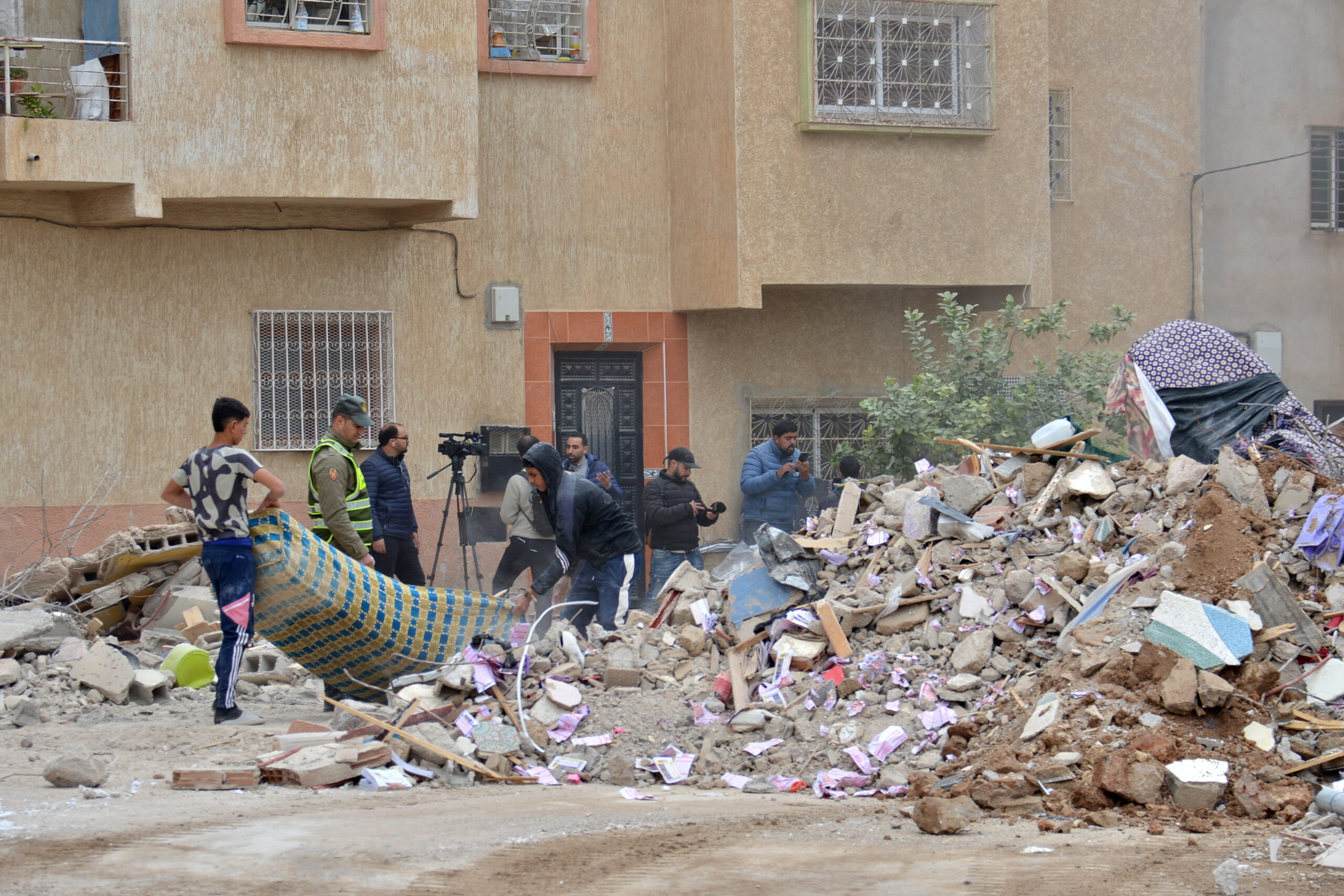 epa12582916 Rescue teams and locals clear the debris of two collapsed buildings in Fez, Morocco, 10 December 2025. At least 22 people have been killed and 16 injured by the collapse of two buildings in Morocco’s historic city of Fez, according to the state news agency.