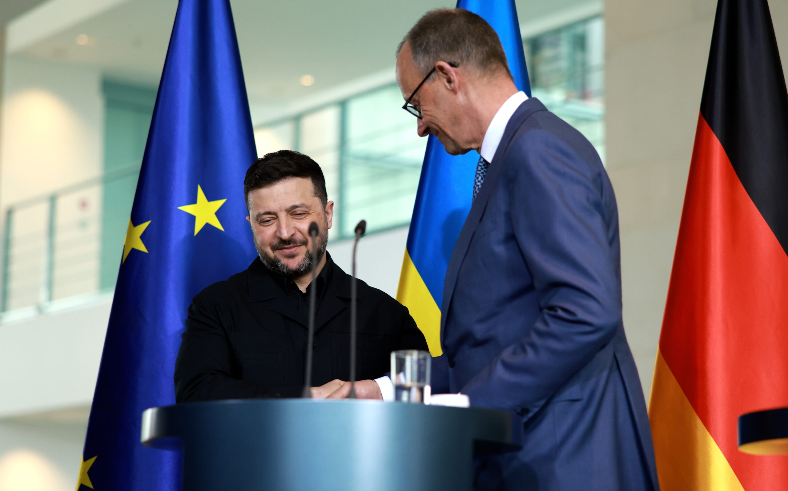 epa12888945 German Chancellor Friedrich Merz (R) and Ukrainian President Volodymyr Zelensky (L) shake hands at the end of a press conference at the Chancellery in Berlin, Germany, 14 April 2026. Following the Hungarian elections on 12 April, the German government expects that the EU’s 90 billion euro loan package for Ukraine will be unblocked swiftly.