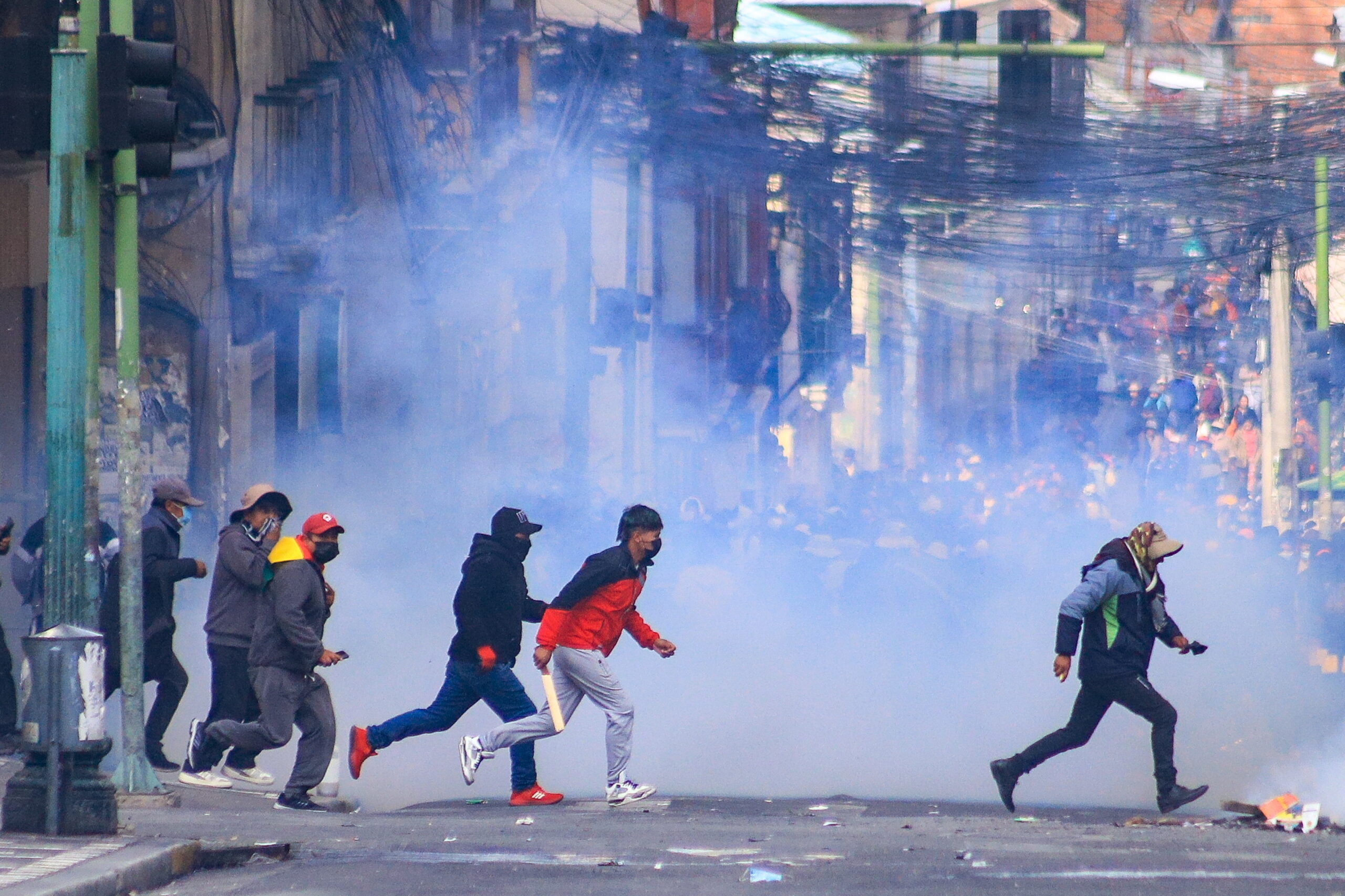 Protesters clash with police during a protest demanding the resignation of President Rodrigo Paz in La Paz, Bolivia, 18 May 2026. The protests converged on Plaza Murillo, the site of the Presidential Palace and Parliament, guarded by police and military forces. Riot police deployed tear gas to suppress the protesters' advance, who countered with firecrackers and dynamite explosions.