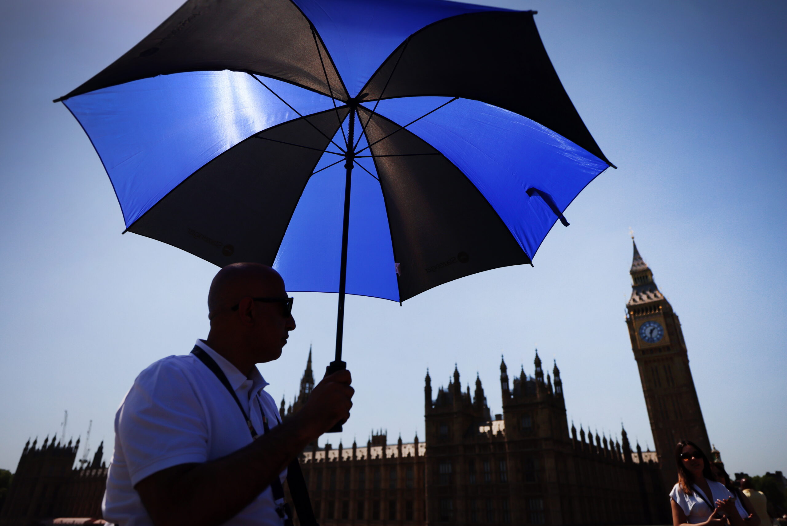 A pedestrian shelters from the sun on Westminster Bridge in London, Britain, 25 May 2026. The UK has recored it’s hottest May day on record expected to reach temperatures of 35 Celcius as a heat wave continues.
