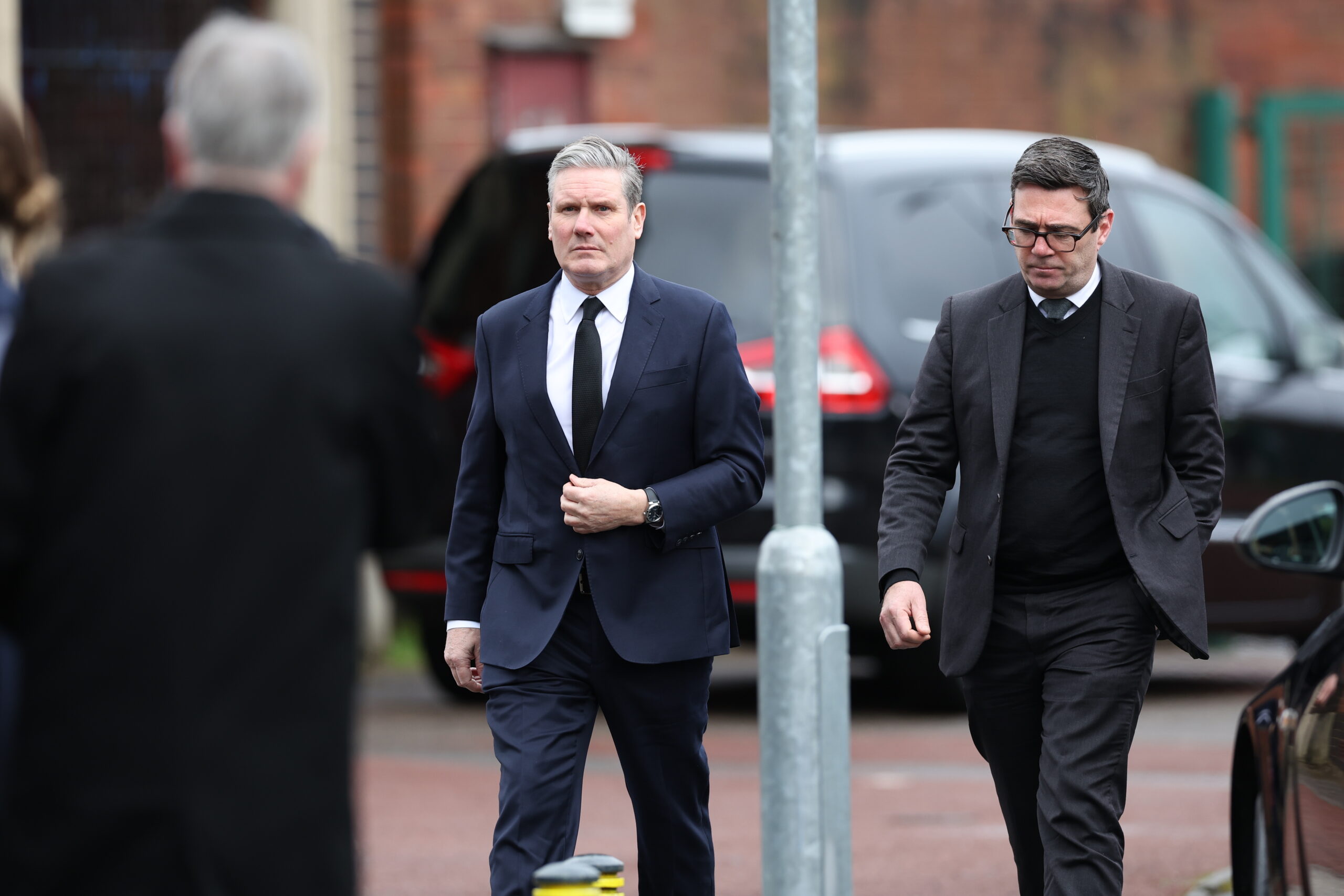 Leader of the Labour Party Keir Starmer (C) and Mayor of Manchester Andy Burnham (R) arrive to attend the funeral of Sir Tony Lloyd at St. Hugh of Lincoln RC Church in Stretford, Britain, 16 February 2024. Sir Tony Lloyd died on 17 January 2024 having served as a Labour Member of Parliament for 36 years, representing Stratford, Manchester Central and Rochdale.