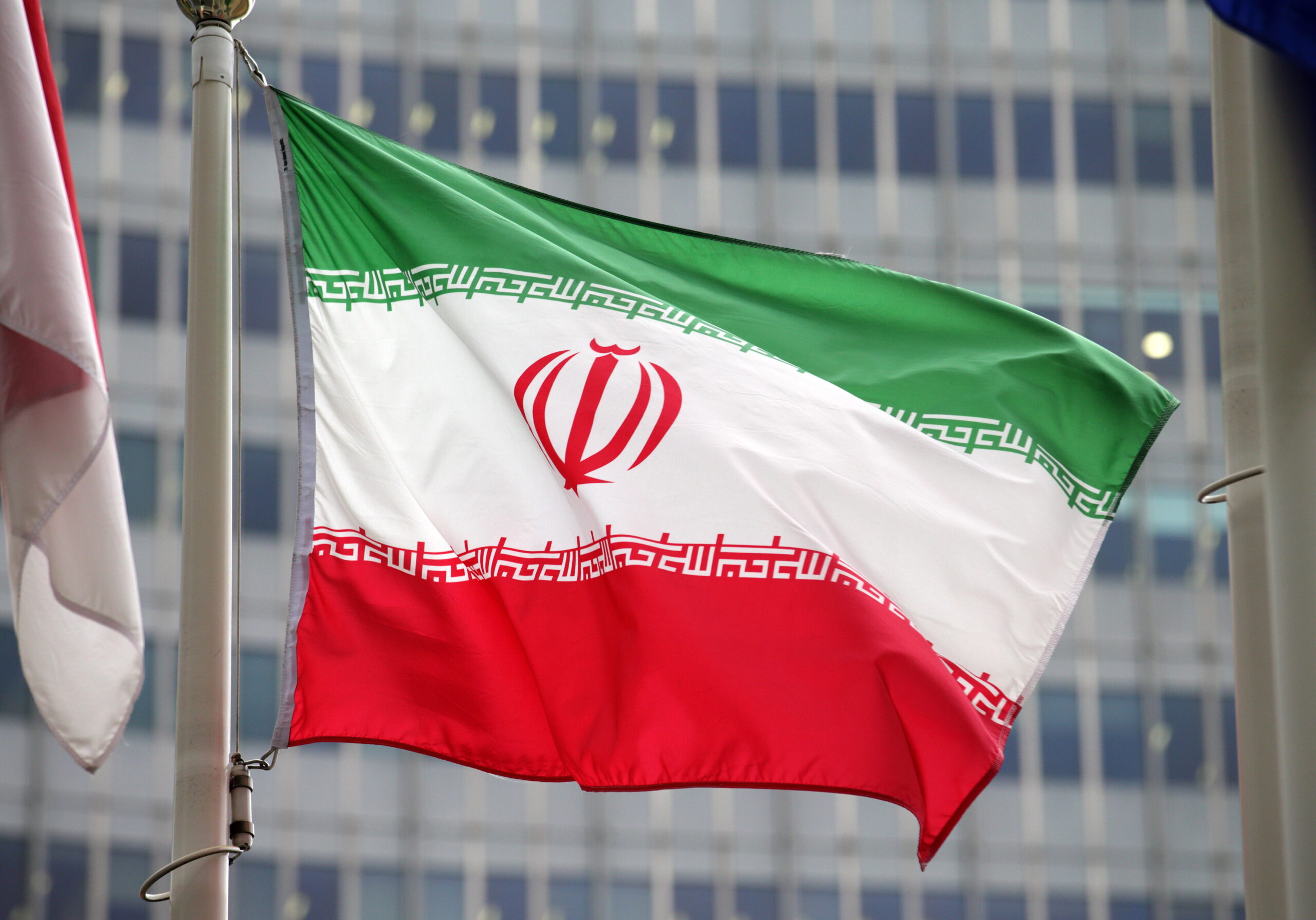 Iran's flag flies outside the International Atomic Energy Agency (IAEA) headquarters during the opening session of an IAEA Board of Governors meeting in Vienna, Austria, 20 November 2024.