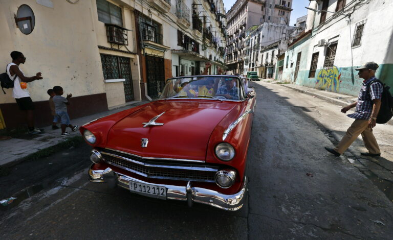 People walk past a 1955 Ford classic car in Havana, Cuba, 29 May 2026.
