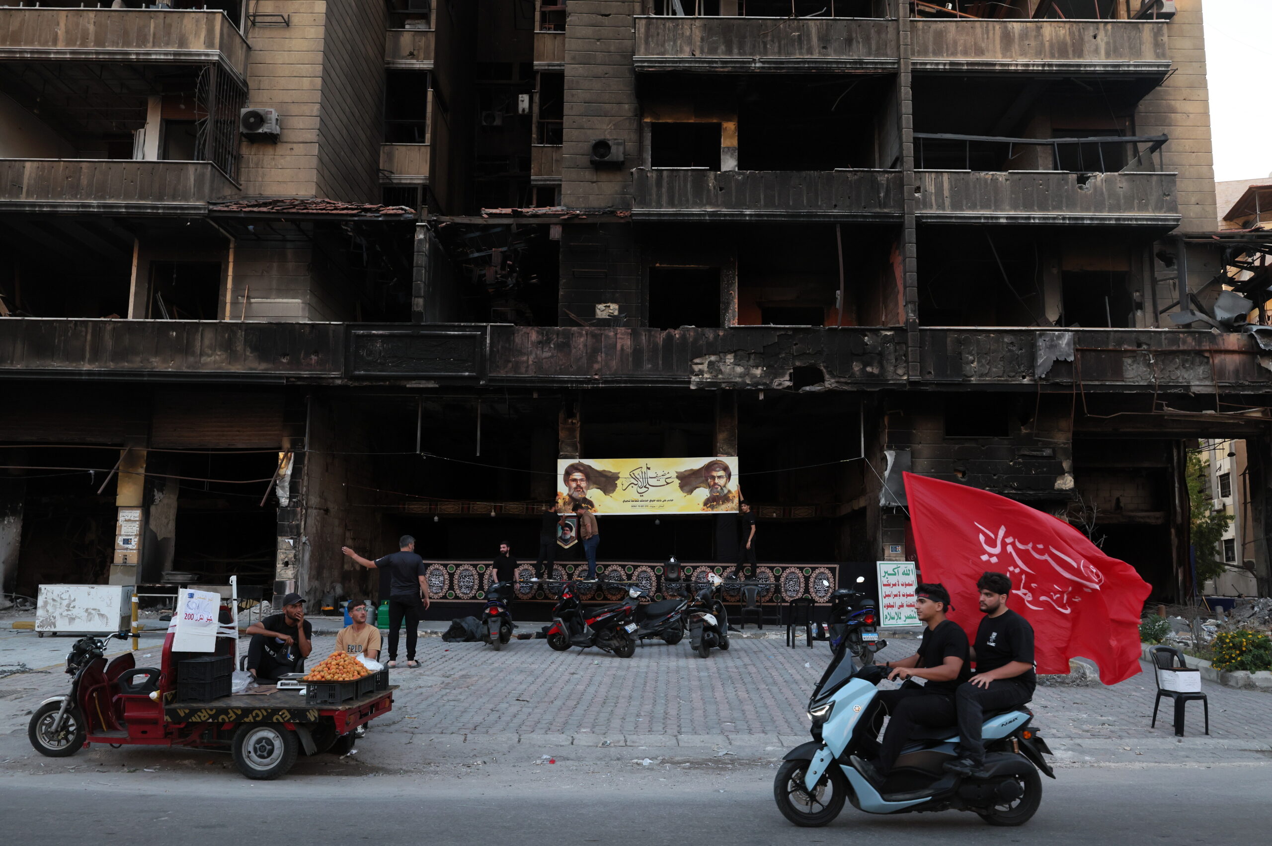 Supporters of Hezbollah hang a banner depicting portraits of late Hezbollah leaders Hassan Nasrallah (R) and Hashem Safieddine (L) in a partially damaged building targeted by an Israeli strike, during the first day of Ashura in the southern suburbs of Beirut, Lebanon, 17 June 2026. Shiite Muslims across the world are observing the holy month of Muharram, the first month of the Islamic calendar, which culminates with the celebration of the Ashura festival, commemorating the martyrdom of Imam Hussein, a grandson of the Prophet Muhammad.