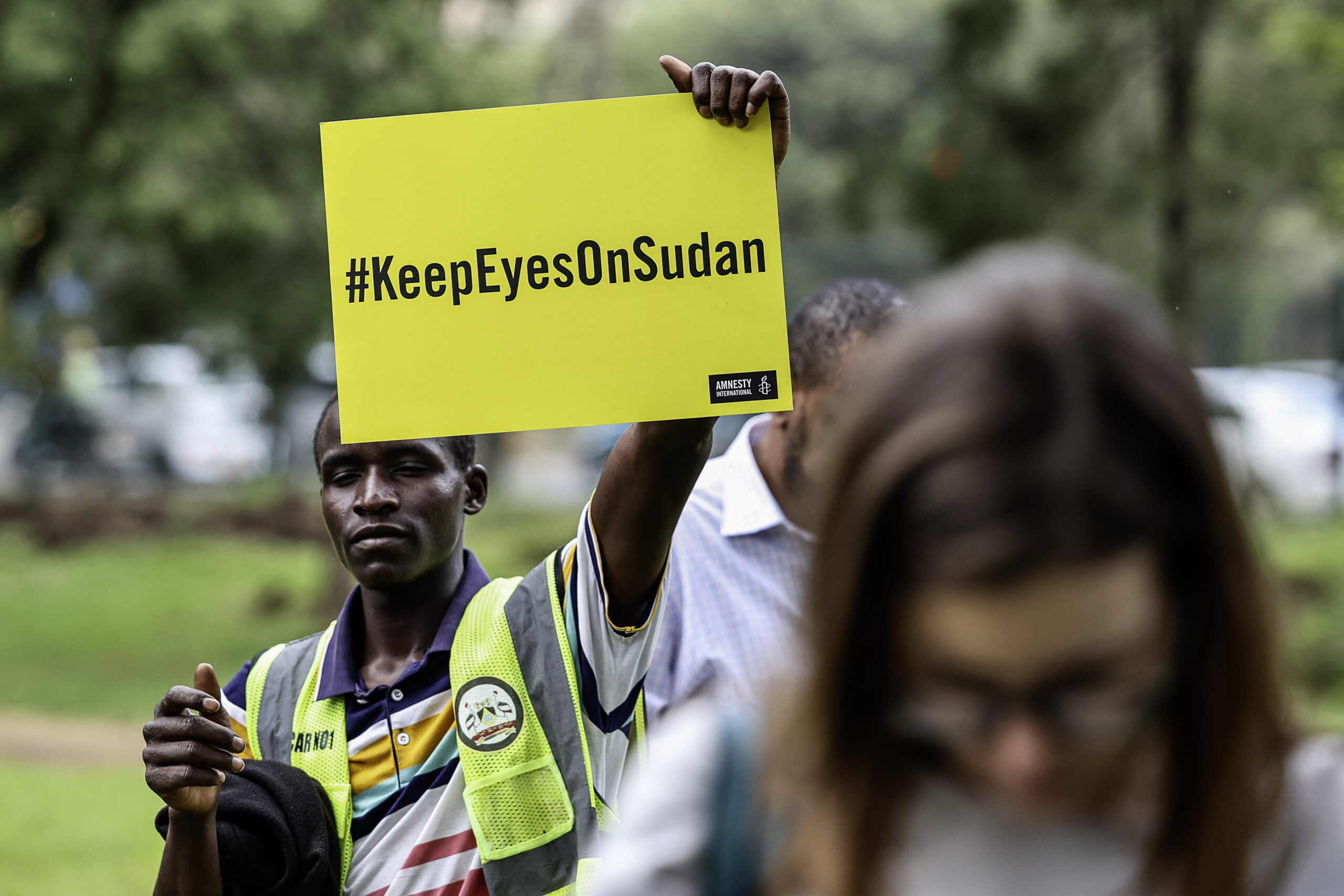 Some of the Sudanese civilian refugees and human rights activists hold placards with the wordings, 'KeepEyesOnSudan' during a commemorative gathering dubbed 'Under the Neema (Tree)' to mark the third anniversary since the war in Sudan started, organized by the Amnesty International at the Freedom Corner in Nairobi, Kenya, 15 April 2026. According to an Amnesty International report, since 2023, tens of thousands of people have been killed and nearly 14 million have been displaced. Both sides of the conflict are violating human rights resulting in mass civilian casualties, gender-based violence and a humanitarian catastrophe that has arisen from aid being blocked.