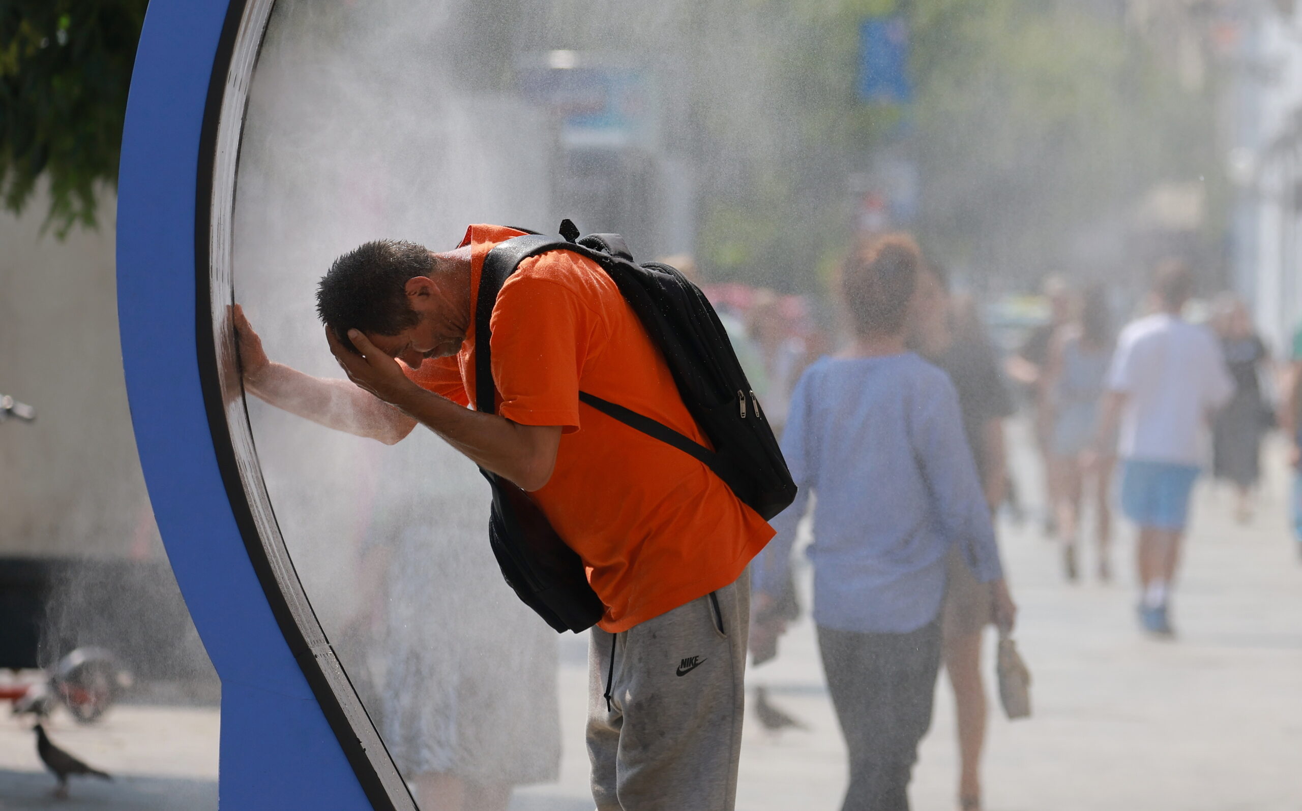 A Romanian man cools off on one of the hottest days of June by sitting inside a water-spraying device installed in the city centre in Bucharest, Romania, 30 June 2026. Bucharest is under a Code Red heatwave warning until 01 July 2026, with temperatures reaching 37 to 39 degrees Celsius.
