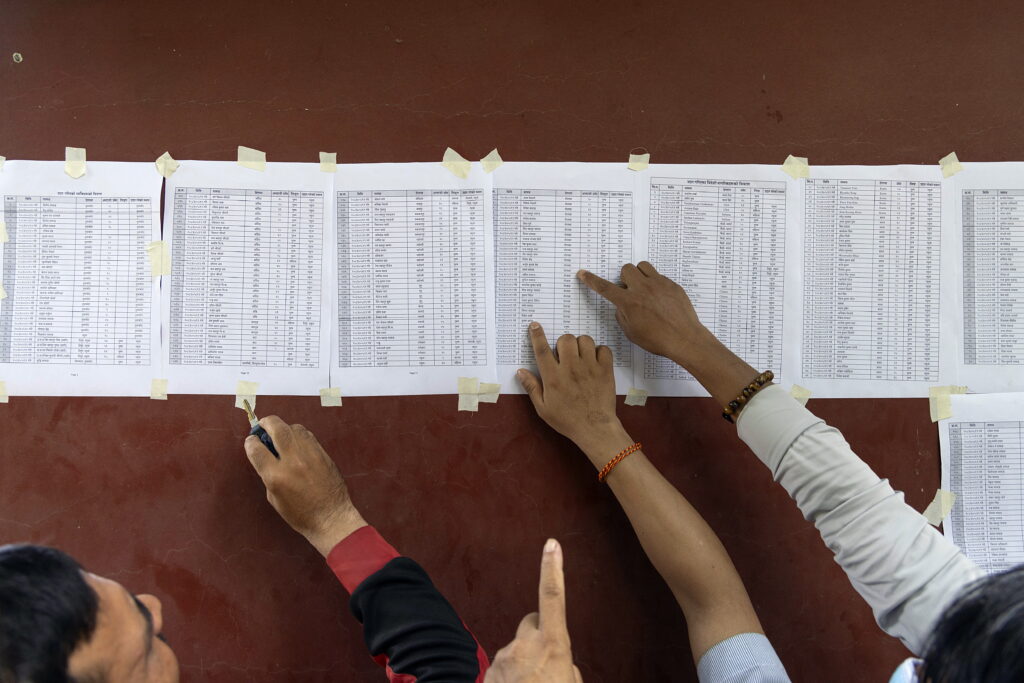 epa13196756 People search the names of their relatives on lists of missing people outside the army operations center in the aftermath of flash floods, in Nuwakot district, Nepal, 28 August 2026. More than 460 people have died and hundreds remain missing across northern Nepal after a suspected glacial collapse and avalanche triggered flash floods and mudslides along the Bhotekoshi and Trishuli river valleys near the Nepal-Tibet border, causing widespread destruction to settlements and infrastructure, according to local authorities. 