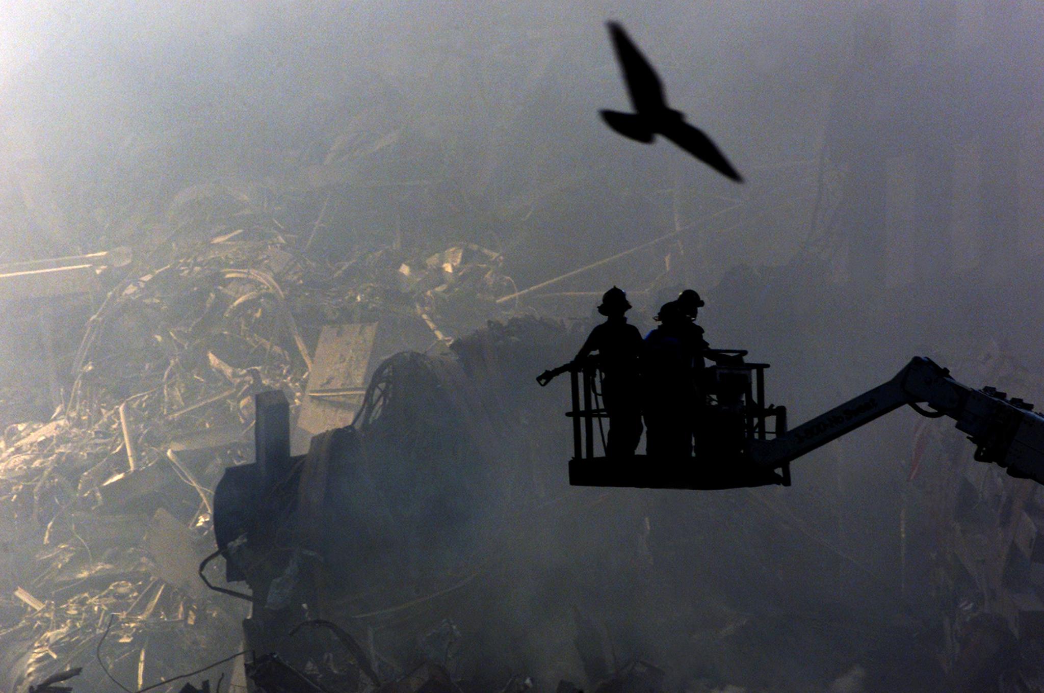 NYC11 - 20010919 - NEW YORK, UNITED STATES : Rescue workers search for life as a bird soars ominously above the still smouldering debris of the destroyed World Trade Center in New York, Wednesday, 19 September 2001. Fire fighters and police are still searching for people who may have survived the 11th September attack but hope is running out someone will still be found alive.