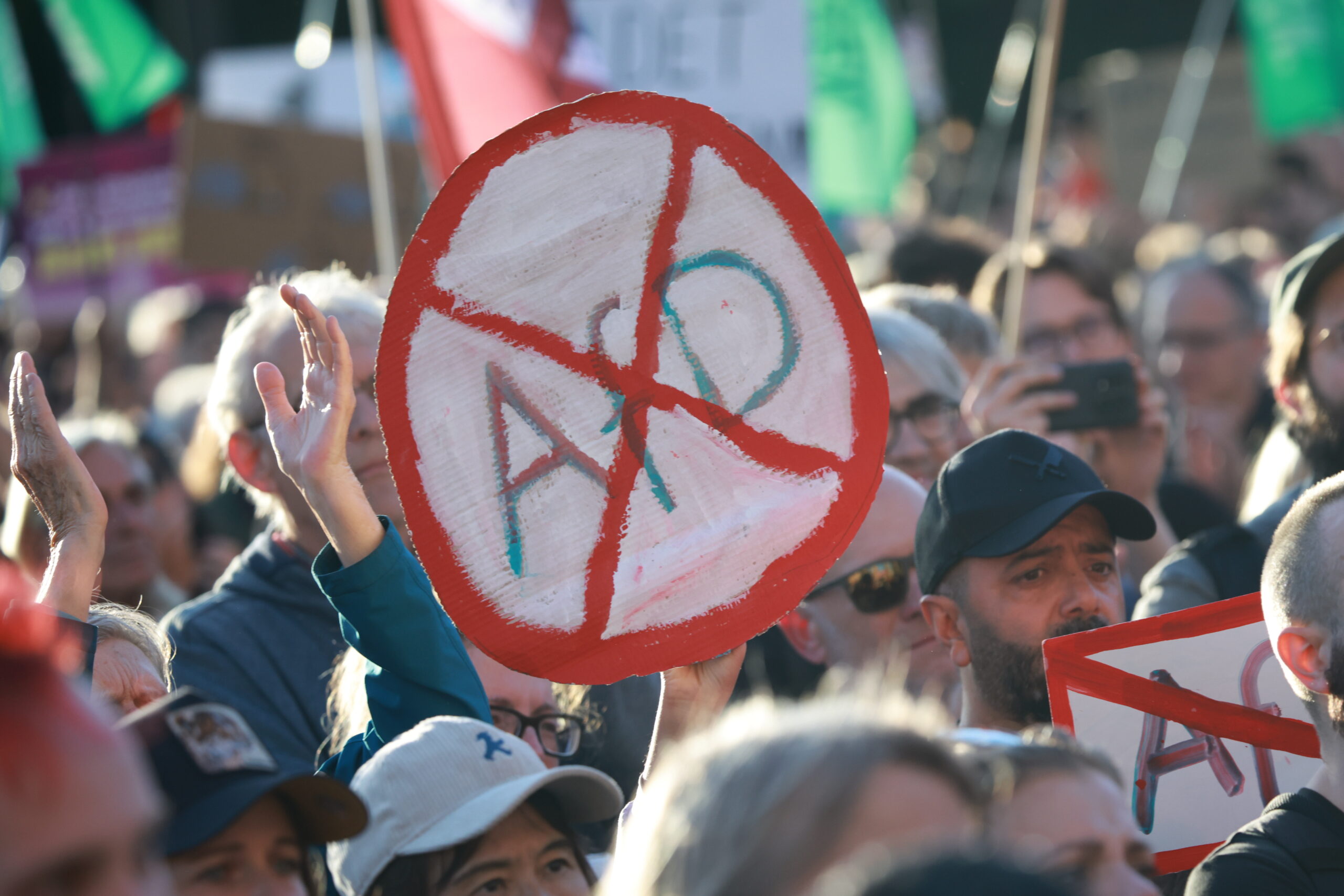 epa13220401 A participant holds a placard that resembles a road sign and shows a crossed out AfD during a rally at the Brandenburg Gate in Berlin, Germany, 07 September 2026. The protest was scheduled a day after the far-right Alternative for Germany party (AfD) won the election in the regional state of Saxony Anhalt by a wide margin.