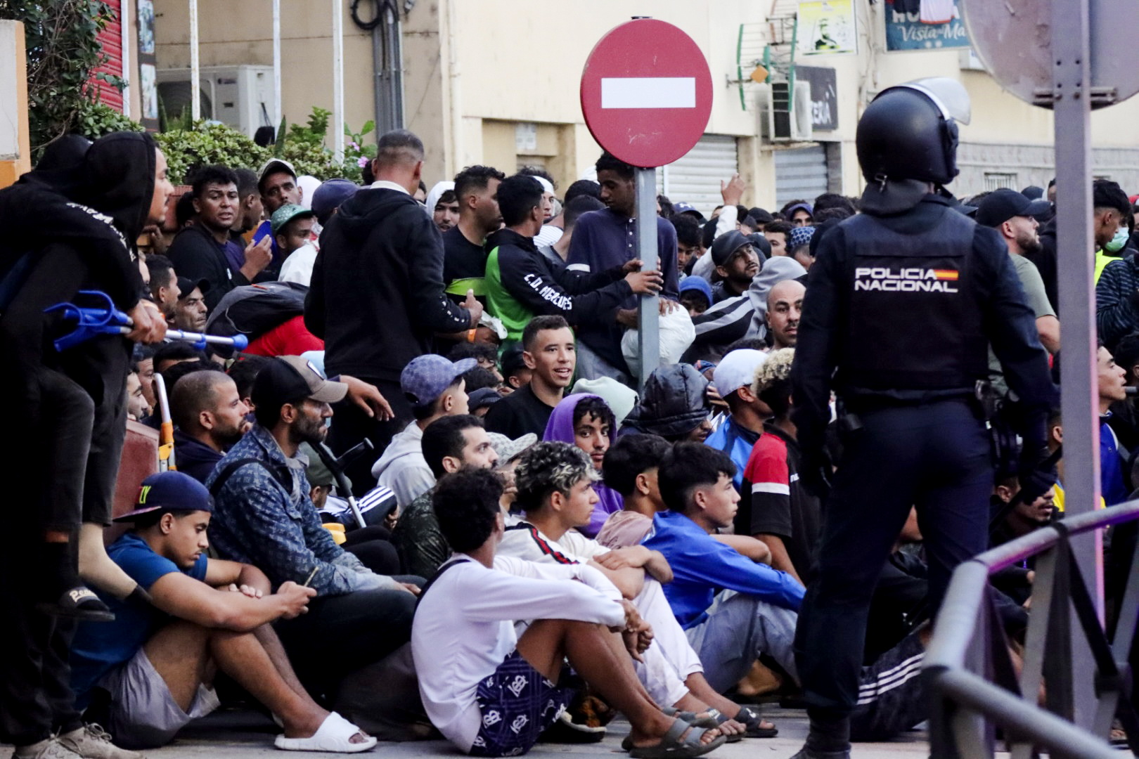 epa13247244 A group of migrants living at Benitez Beach wait to be transferred by Civil Guard members to a newly built pavilion in Ceuta, Spain, 18 September 2026. Spain is dealing with a massive migration crisis in the autonomous region of Ceuta after thousands of people crossed into the North African enclave from Morocco in late July 2026.