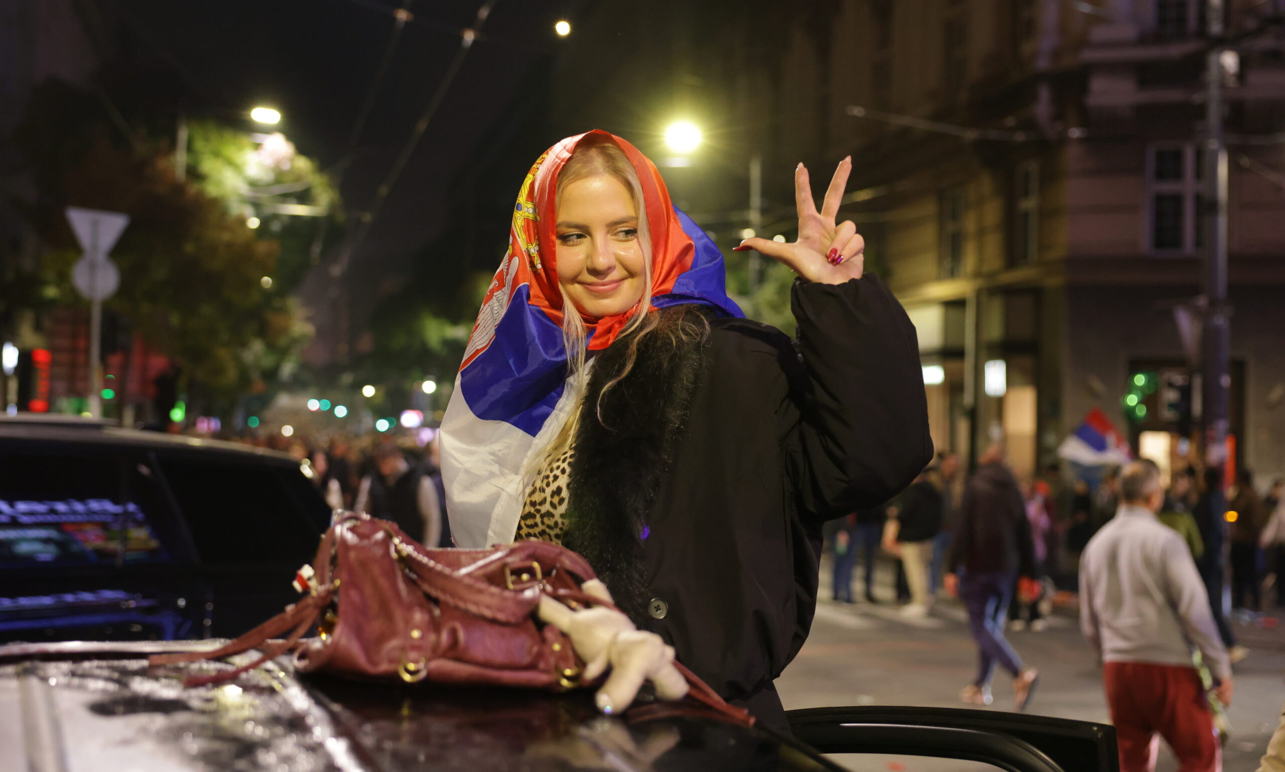 epaselect epa13331984 A supporter of the 'Student List' celebrates after the parliamentary elections in Belgrade, Serbia, 25 October 2026. Roughly 6.5 million eligible voters were called to the polls in a snap parliamentary election to choose lawmakers for a four-year term.