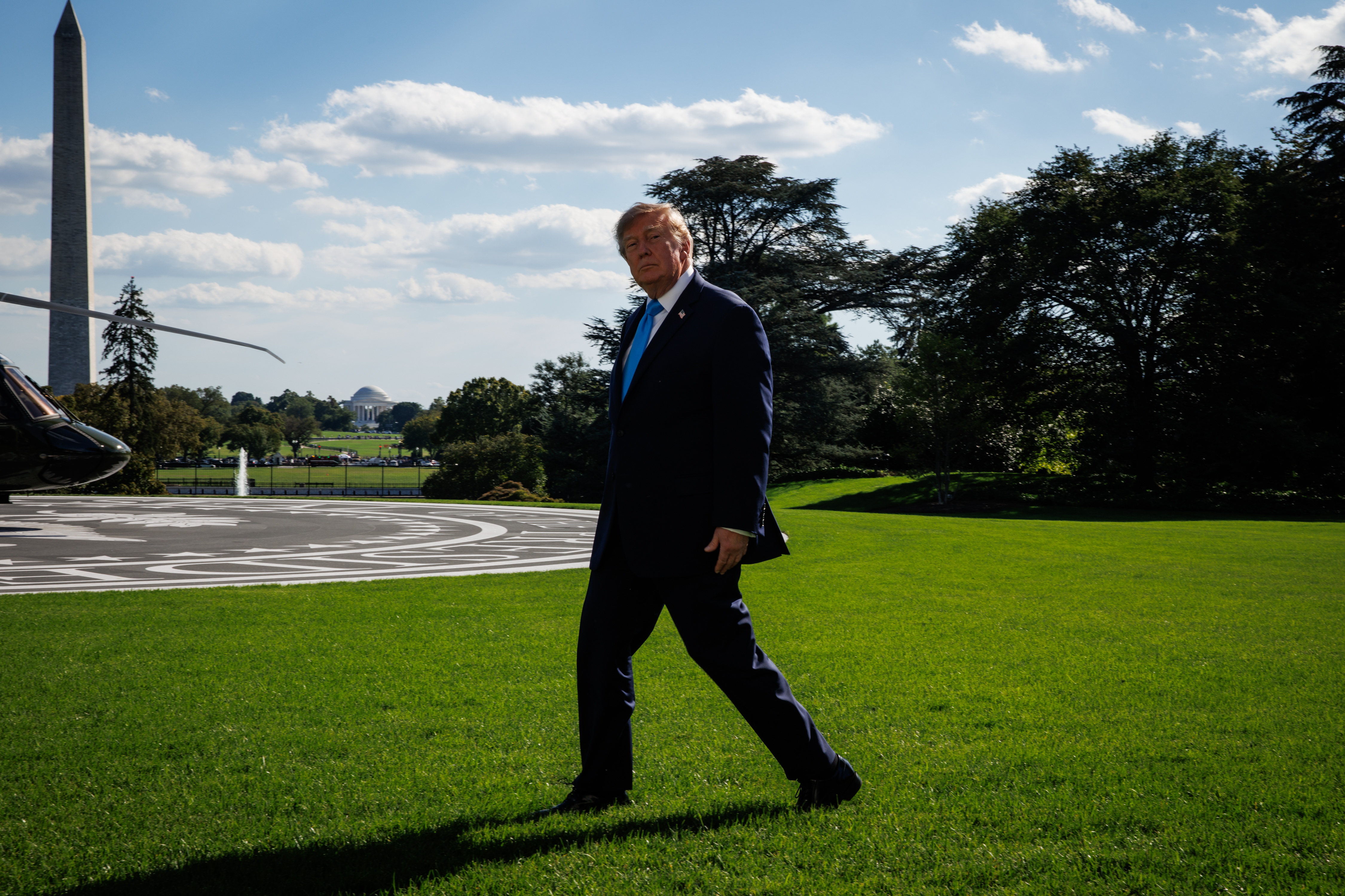 US President Donald J. Trump talks with media prior to his departure from White House