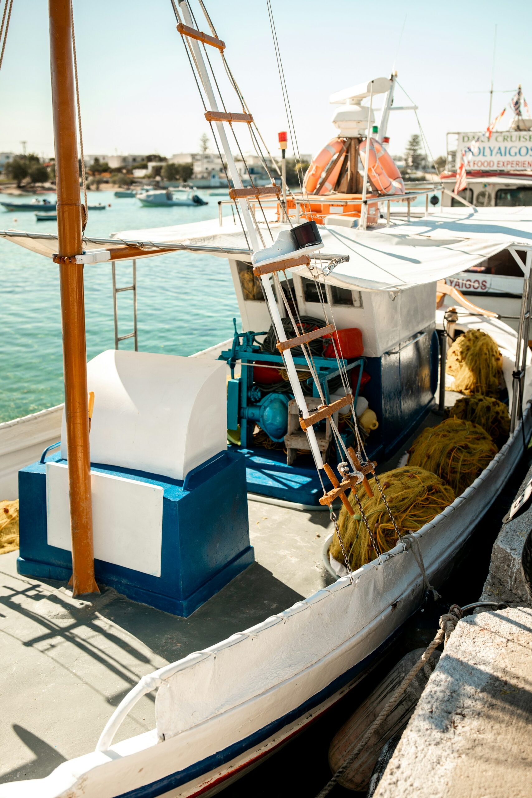 Greek fishing boat with nets docked in milos