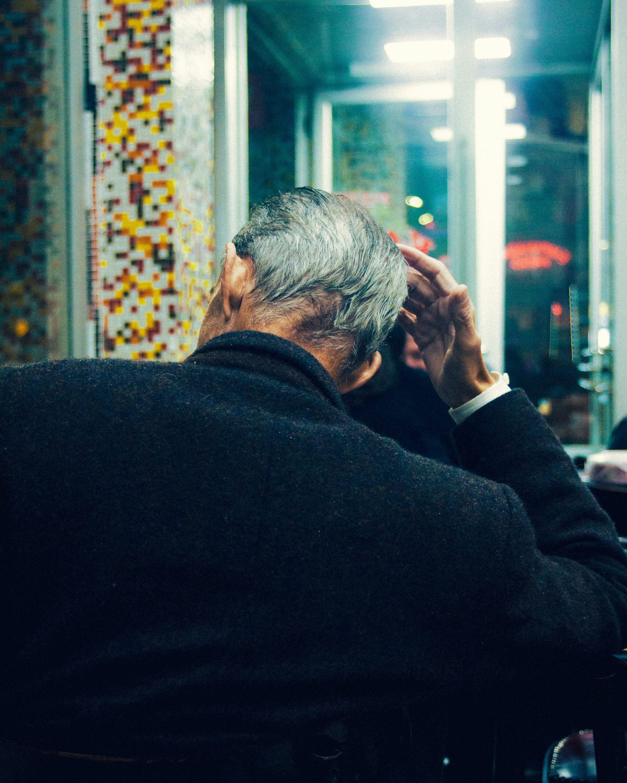 a man sitting at a table in front of a window